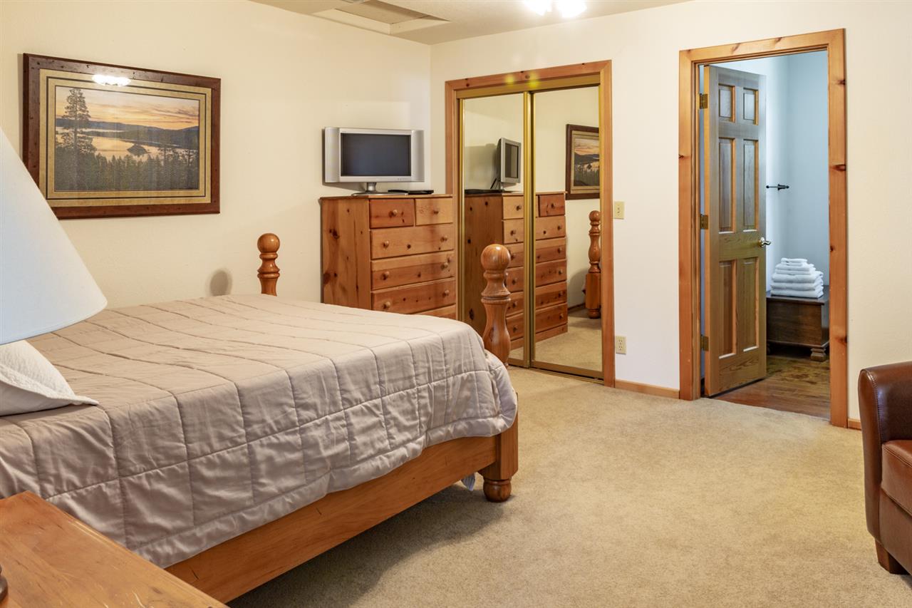 12051 Oslo Drive Truckee, CA 96161 - Photo 19 of 21 a spacious bedroom with a bed and a flat screen tv