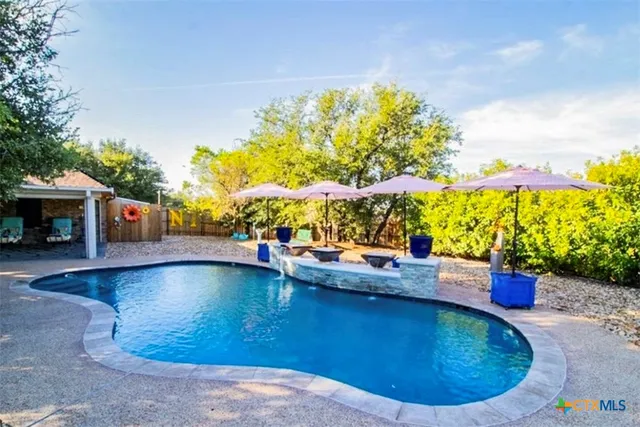 a view of a swimming pool with a patio