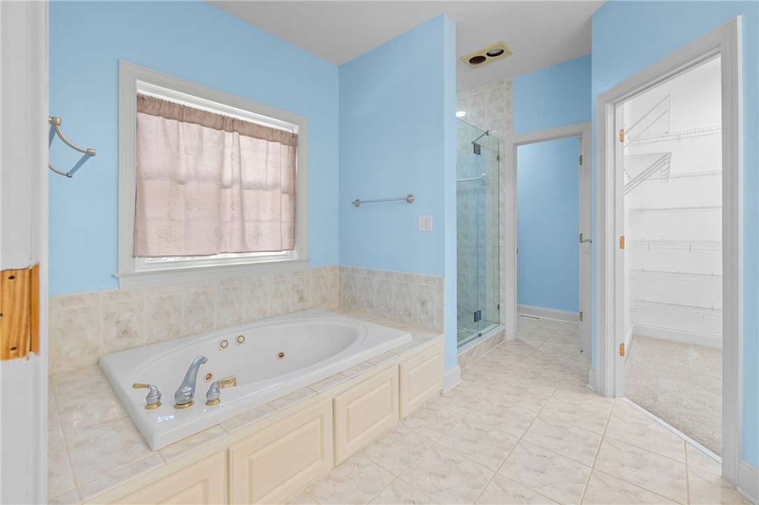 110 Brookstone Way Central, SC 29630 - Photo 24 of 46 This serene bathroom offers a spacious soaking tub and a sleek glass-enclosed shower.