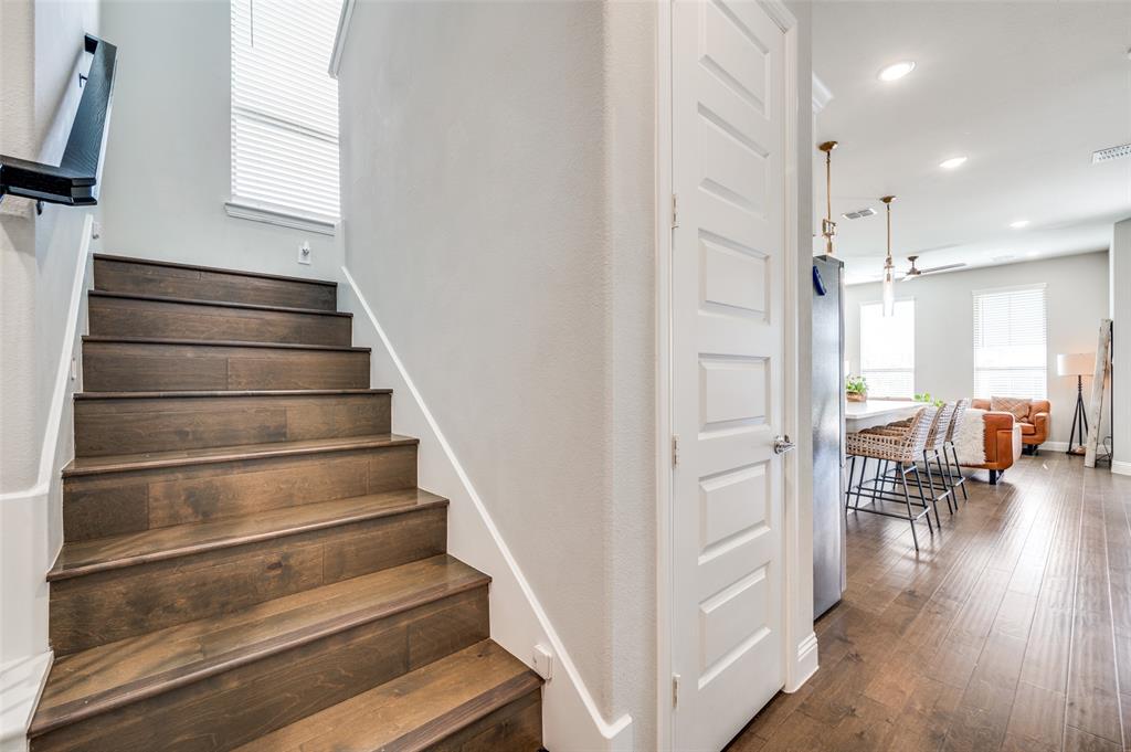 8977 George Cayley Lane Frisco, TX 75034 - Photo 12 of 24 Wooden staircase leads to upstairs living and located off the main entry
