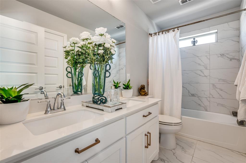 8977 George Cayley Lane Frisco, TX 75034 - Photo 18 of 24 Second floor bathroom with tub and shower