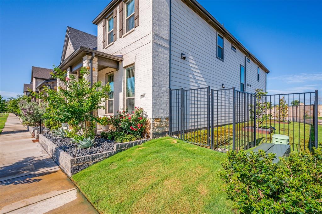 8977 George Cayley Lane Frisco, TX 75034 - Photo 3 of 24 Iron fencing surrounds this additional yard space for pet or play