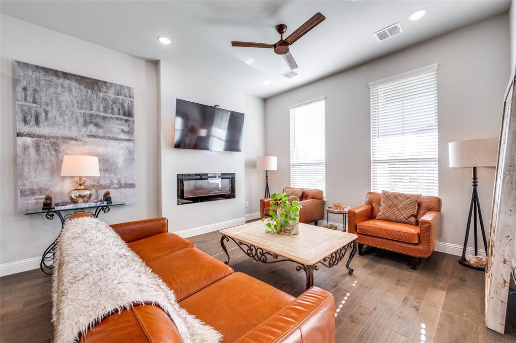 8977 George Cayley Lane Frisco, TX 75034 - Photo 4 of 24 Entry way opens to living space with cozy fireplace for seasonal ambience!