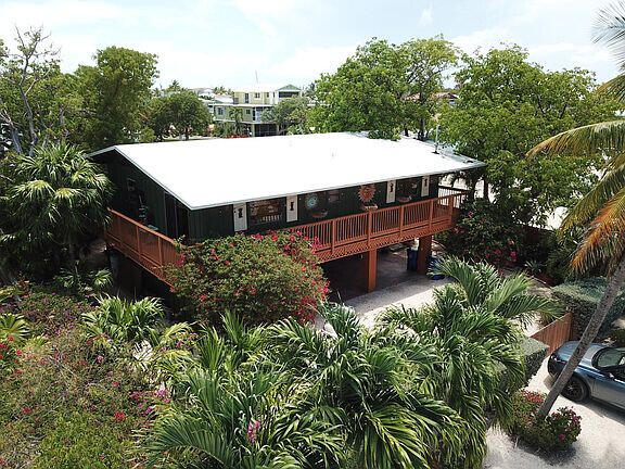 an aerial view of a house with yard and outdoor seating