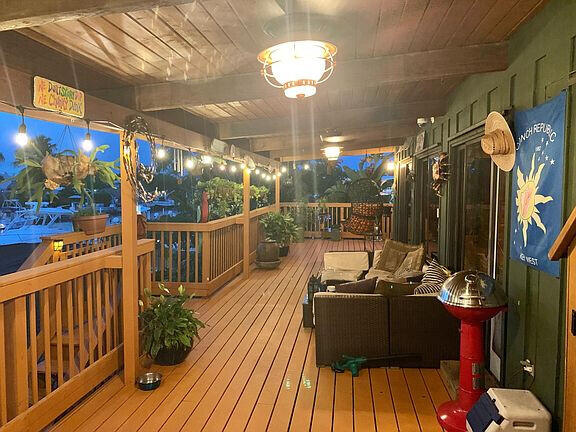 136 Palermo Drive Islamorada, FL 33036 - Photo 12 of 38 a view of a balcony with furniture and wooden floor