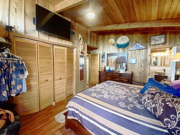 136 Palermo Drive Islamorada, FL 33036 - Photo 22 of 38 a bedroom with a bed and wooden floor