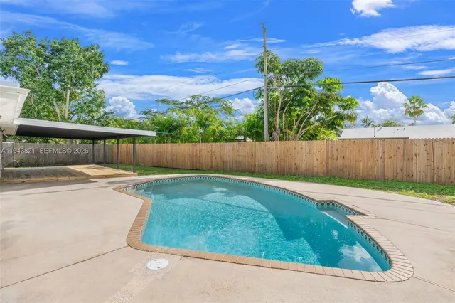 an aerial view of a house with a garden and lake view