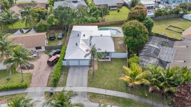 an aerial view of residential houses with outdoor space