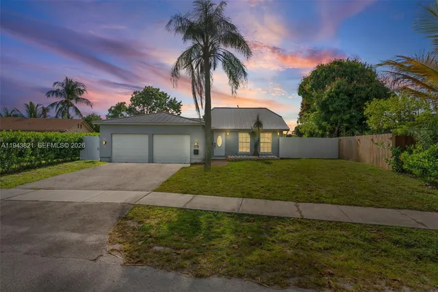 a view of an empty room with wooden floor and window