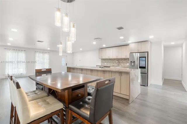 a kitchen with stainless steel appliances granite countertop a sink and cabinets
