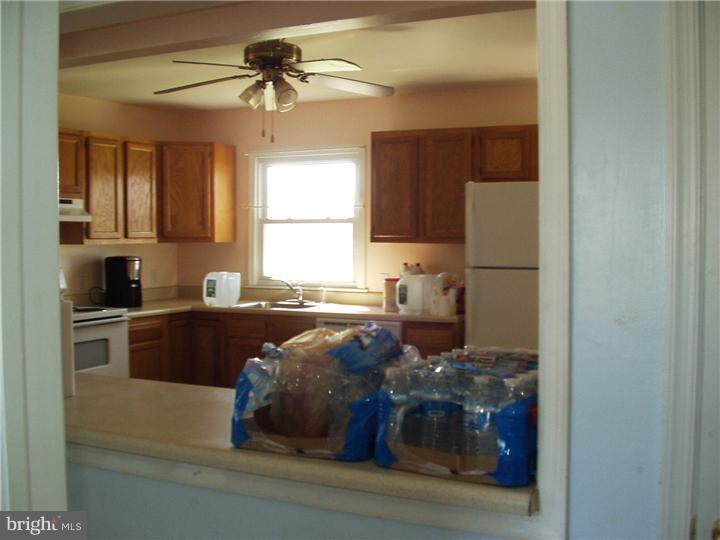 2306 Porter Road Bear, DE 19701 - Photo 5 of 9 a kitchen with a refrigerator and a stove top oven