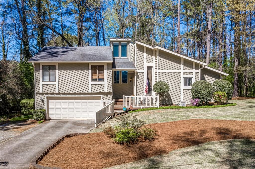 4887 Habersham Ridge Southwest Lilburn, GA 30047 - Photo 1 of 1 a front view of a house with a yard
