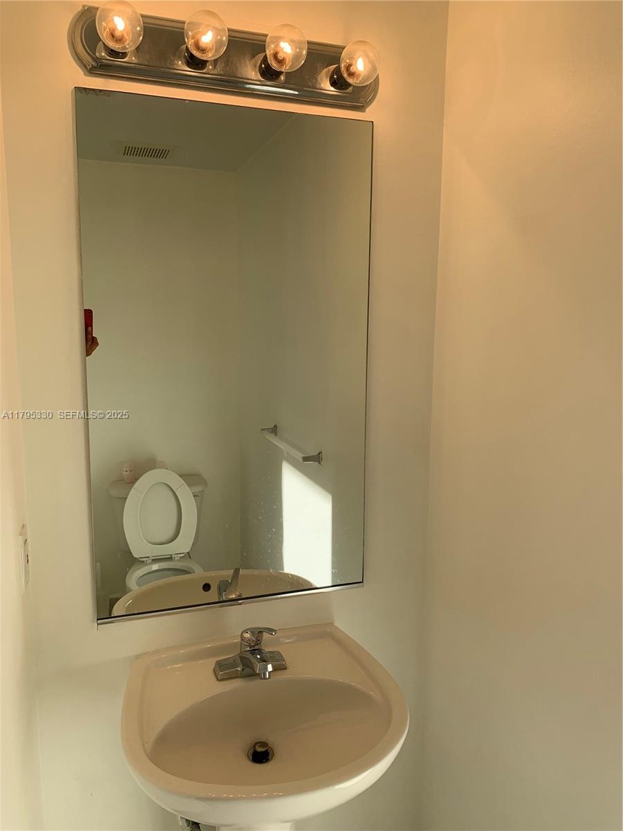 3150 Southwest 152nd Place Miami, FL 33185 - Photo 24 of 47 a bathroom with a sink and mirror
