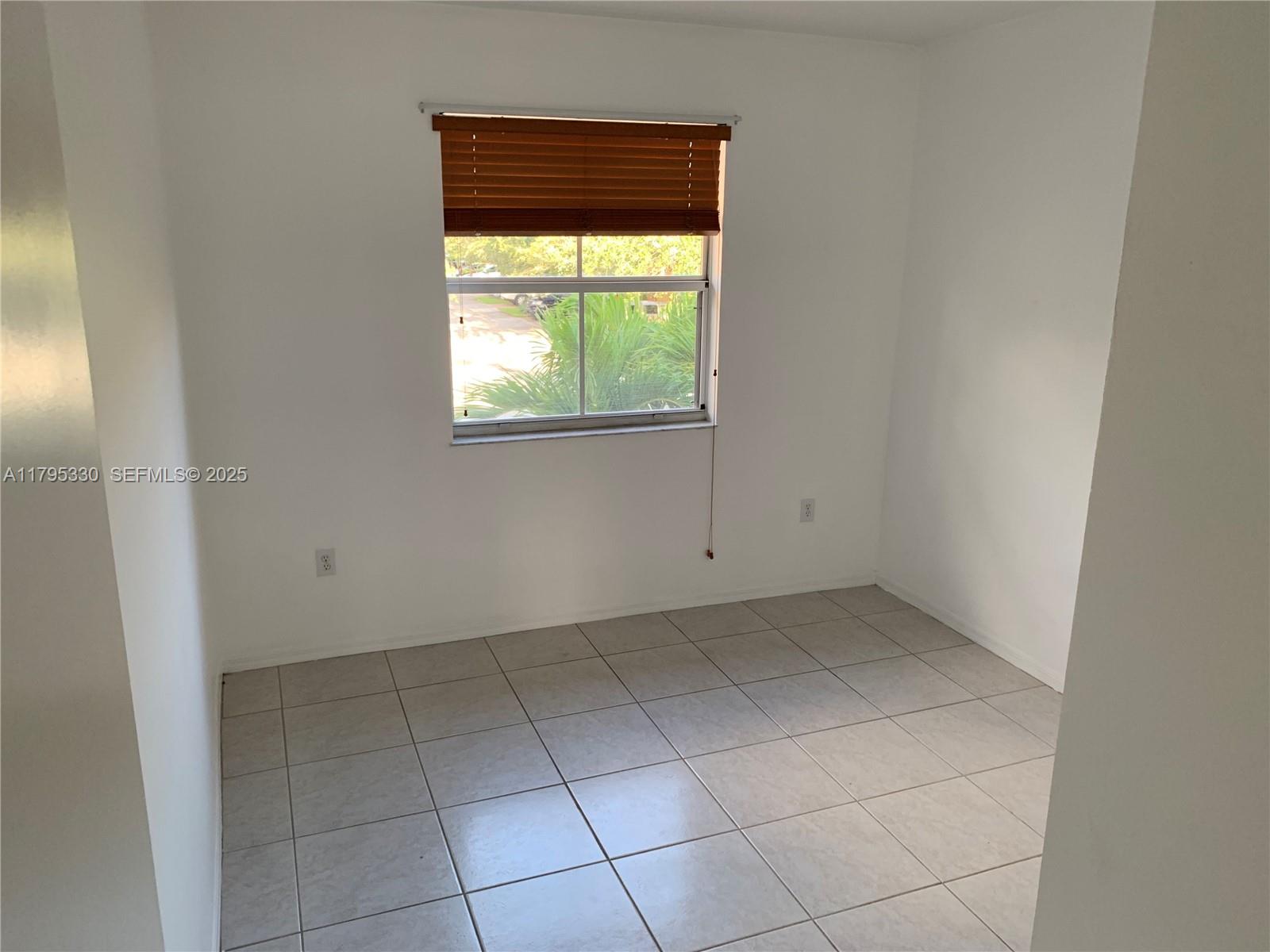 3150 Southwest 152nd Place Miami, FL 33185 - Photo 30 of 47 an empty room with a window
