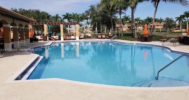3150 Southwest 152nd Place Miami, FL 33185 - Photo 5 of 47 a view of swimming pool with outdoor seating and a patio