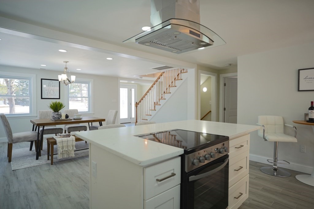 28 Chamberlain Road Chelmsford, MA 01824 - Photo 13 of 38 a kitchen with a stove a table and chairs in it
