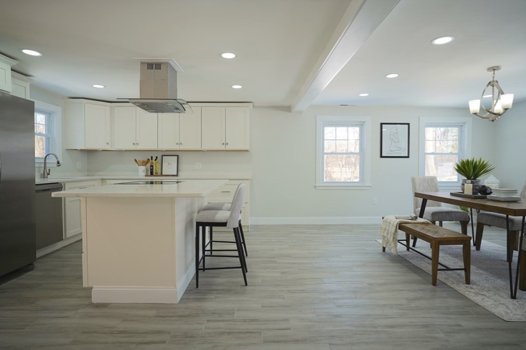 28 Chamberlain Road Chelmsford, MA 01824 - Photo 9 of 38 a kitchen with kitchen island white cabinets and stainless steel appliances