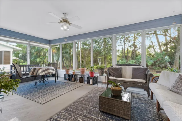 a living room with furniture and large windows