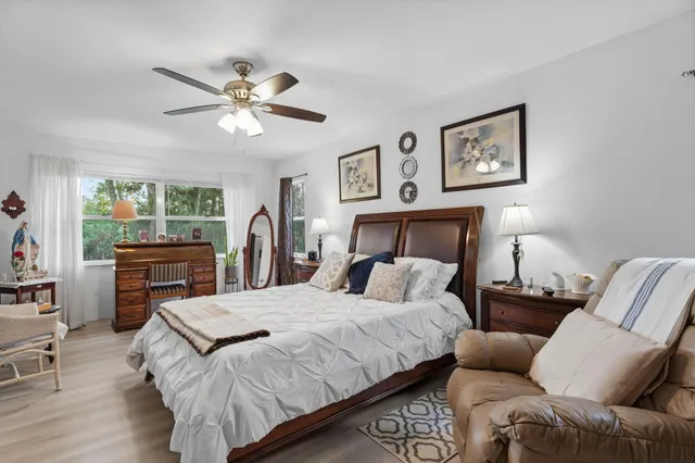 a bedroom with a bed couch and a window