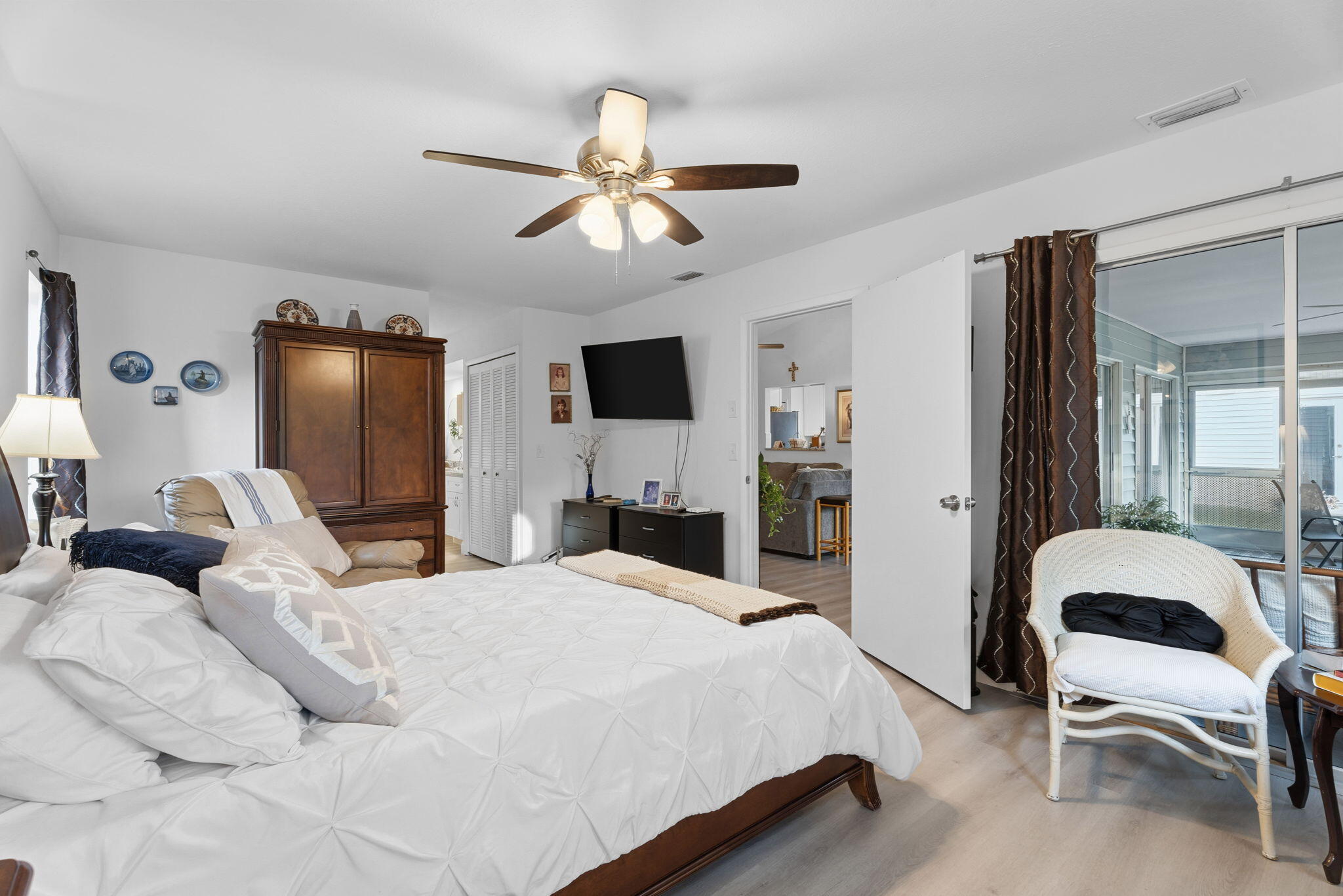 3822 Southeast Canvasback Place Stuart, FL 34997 - Photo 22 of 38 a bedroom with a bed couch and window