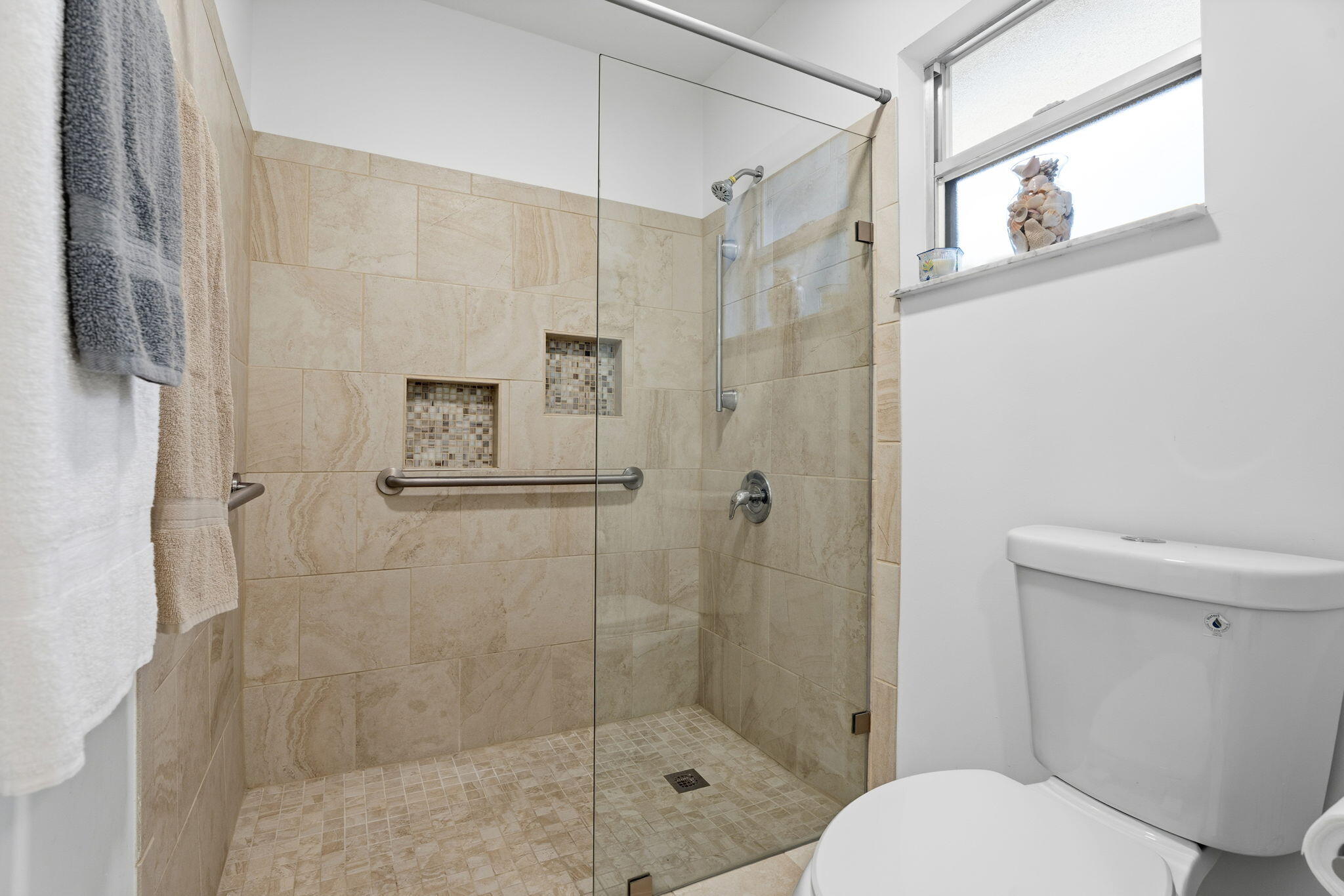3822 Southeast Canvasback Place Stuart, FL 34997 - Photo 25 of 38 a bathroom with a shower a toilet and a sink
