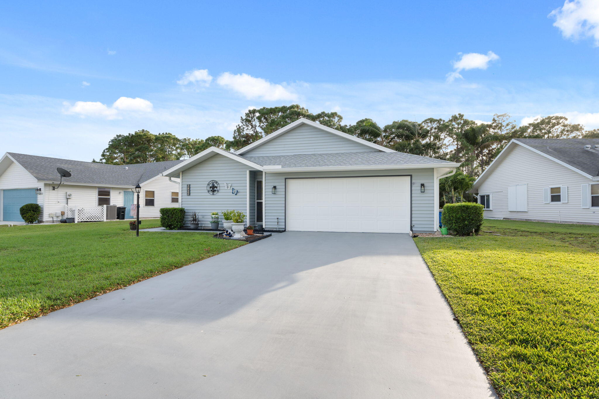 3822 Southeast Canvasback Place Stuart, FL 34997 - Photo 29 of 38 a front view of a house with a yard and garage