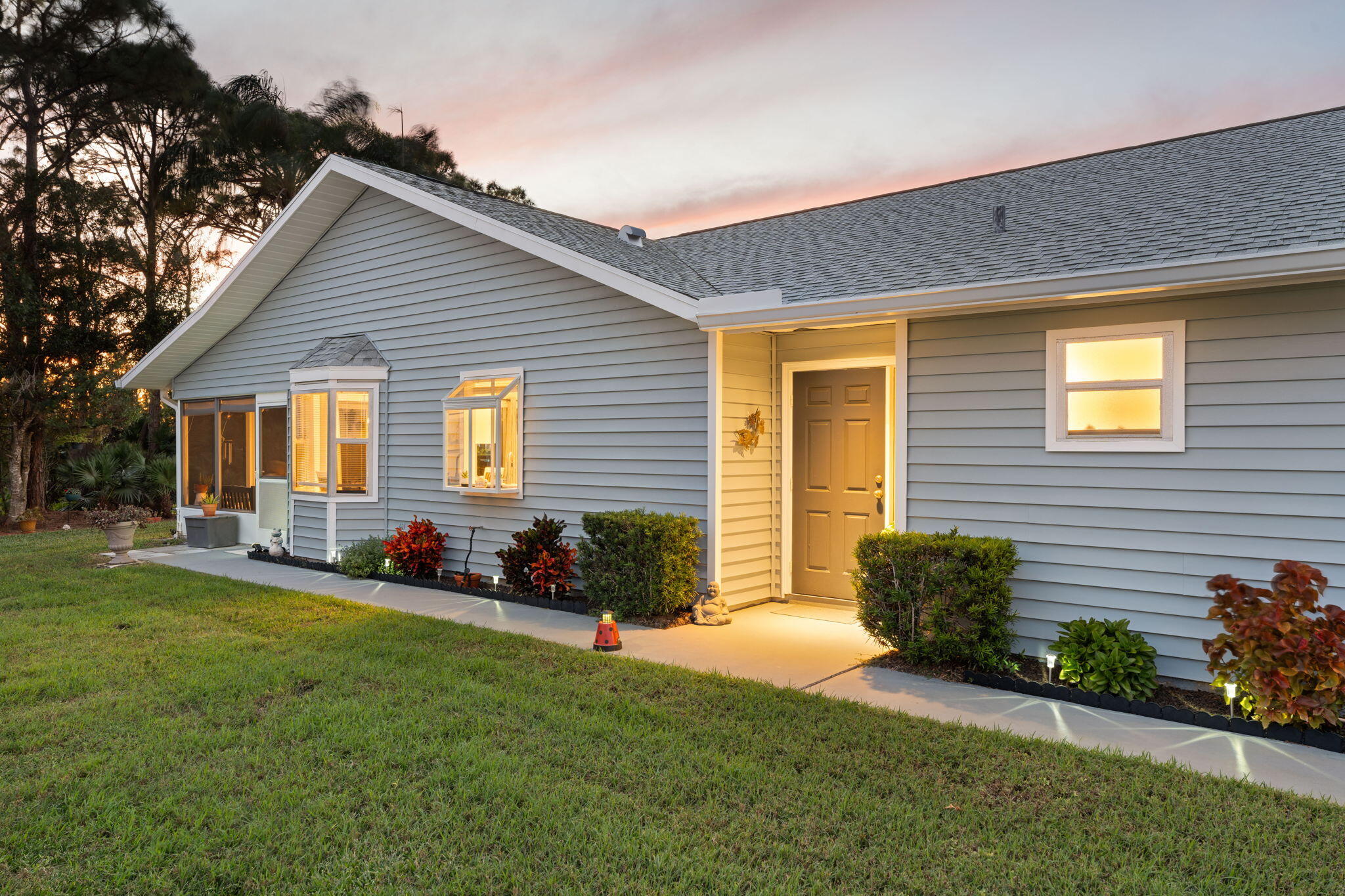 3822 Southeast Canvasback Place Stuart, FL 34997 - Photo 3 of 38 a front view of house with yard and green space