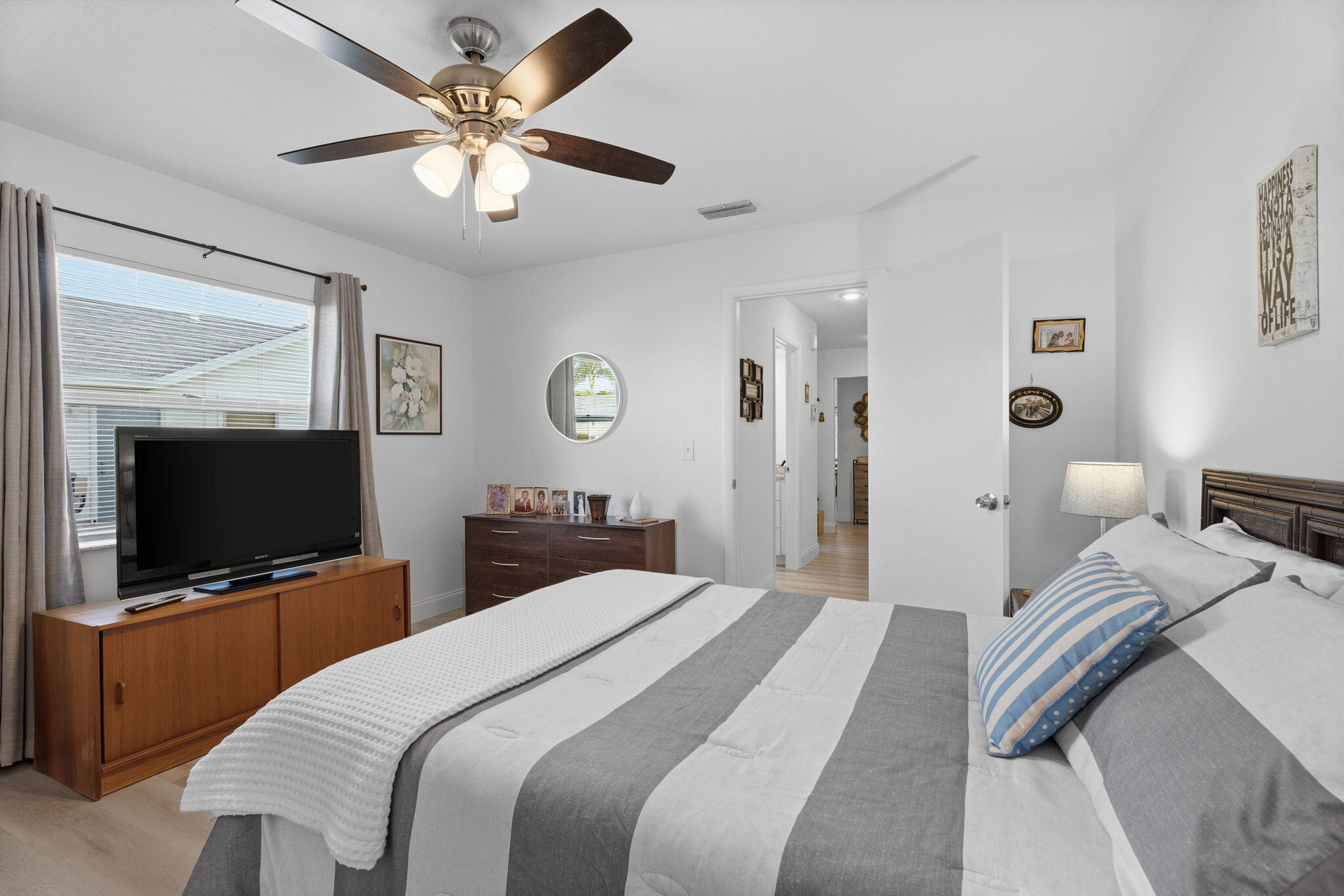 3822 Southeast Canvasback Place Stuart, FL 34997 - Photo 32 of 38 a bedroom with a bed and a flat screen tv
