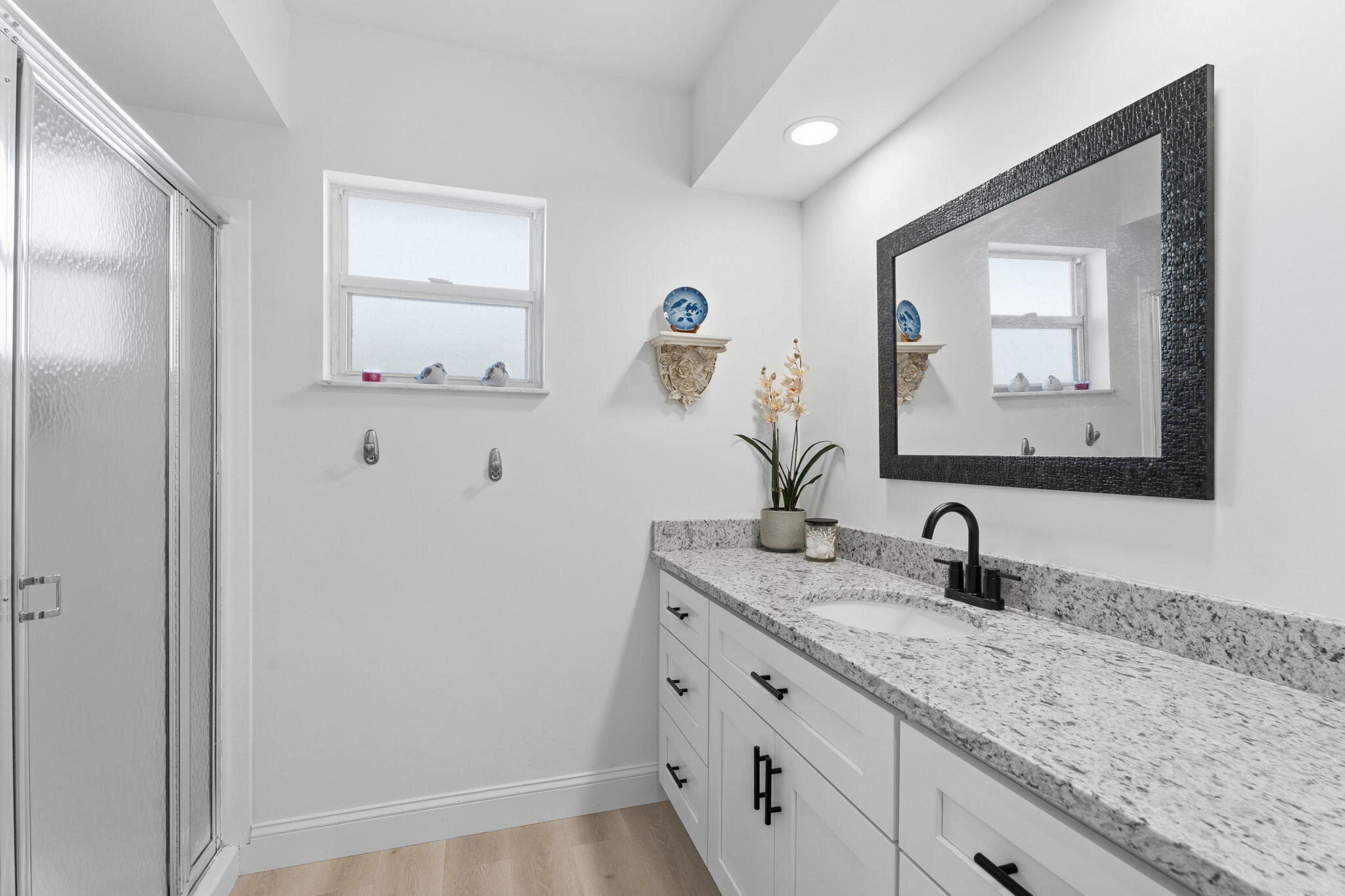 3822 Southeast Canvasback Place Stuart, FL 34997 - Photo 33 of 38 a bathroom with a granite countertop sink and a mirror