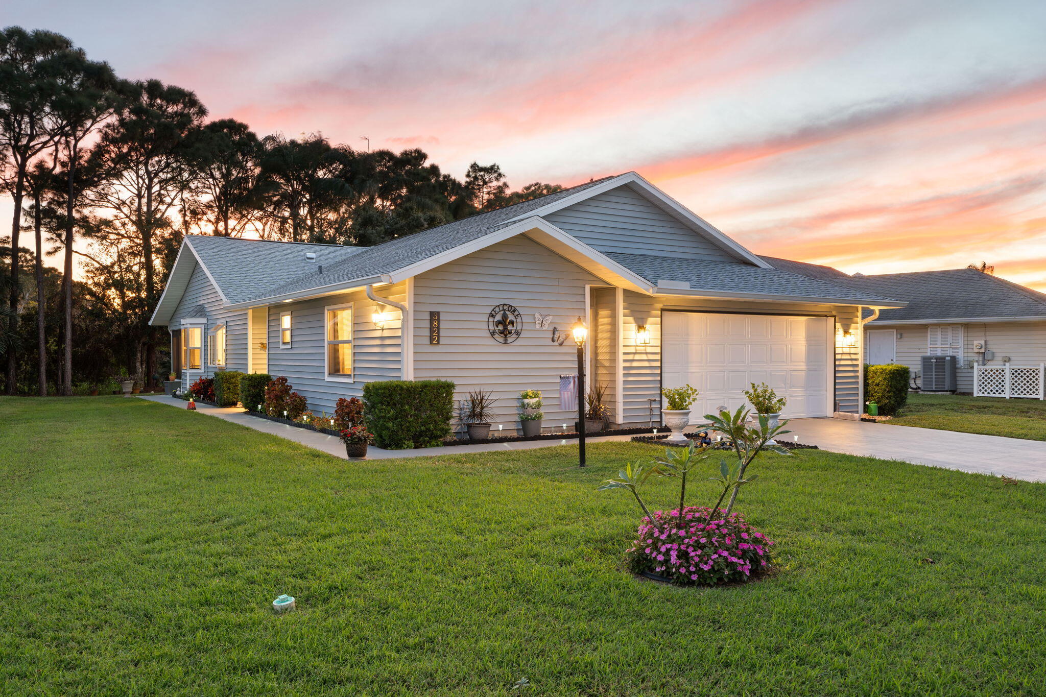 3822 Southeast Canvasback Place Stuart, FL 34997 - Photo 37 of 38 a front view of a house with a yard