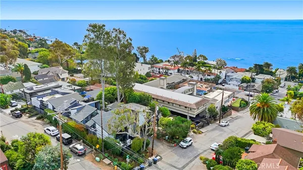an aerial view of a house with a yard lake view