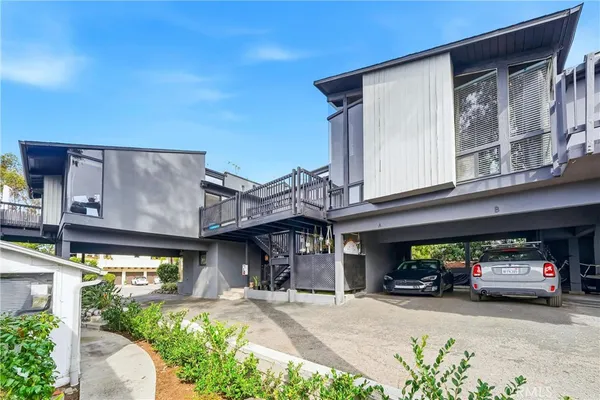 a view of a house with car parked