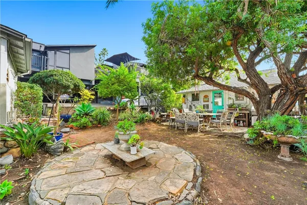 a view of a patio with chairs and plants