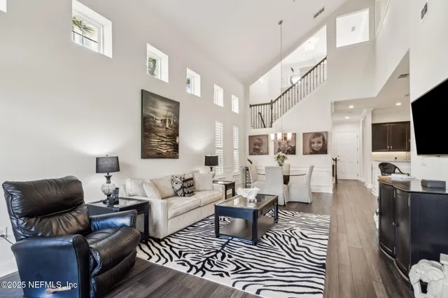 a dining room with furniture and wooden floor