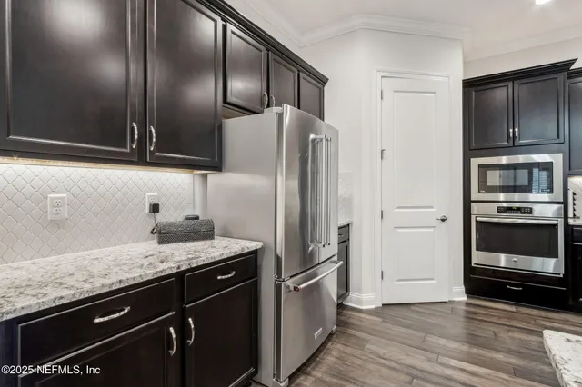 a bathroom with a granite countertop sink two mirror and a