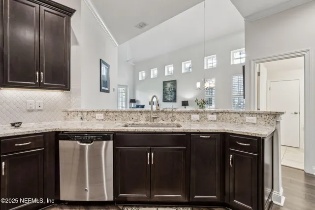 a spacious bedroom with a bed a dresser and next to a window