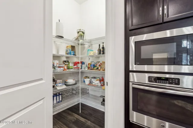 a bedroom with bed and wooden floor