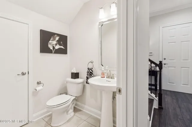 a bedroom with two beds and painting on the wall