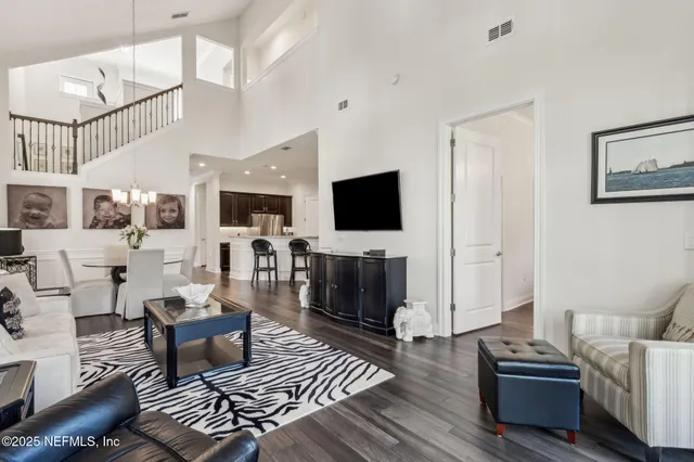 a dining room with furniture and wooden floor