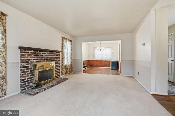 a view of empty room with a fireplace
