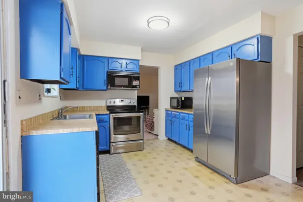 a kitchen with a refrigerator sink and stove