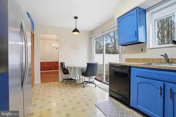 a kitchen with stainless steel appliances kitchen island granite countertop a refrigerator a stove a sink and dishwasher