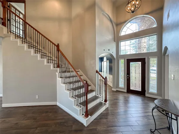 a view of an entryway with wooden floor and a front door