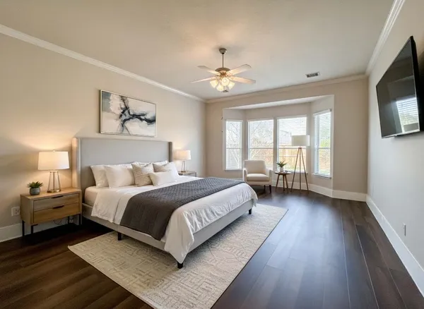 a bedroom with a large bed chandelier and a window