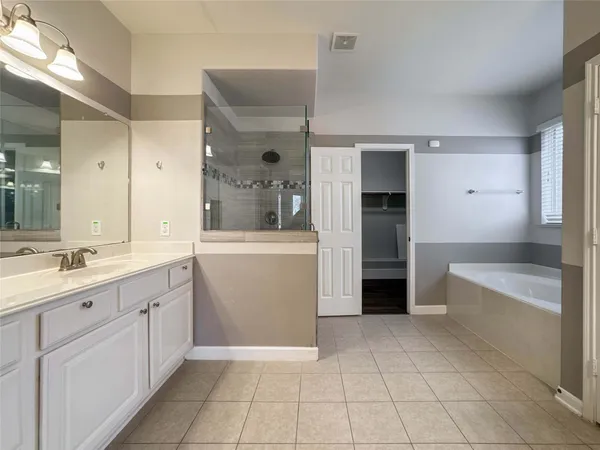 a bathroom with a granite countertop sink a toilet and bathtub