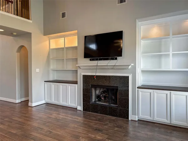 a living room with a fireplace and a flat screen tv