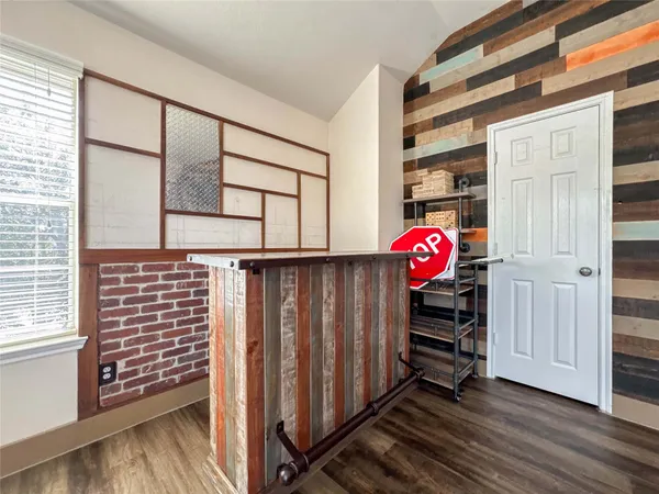 a view of front door with wooden floor and windows