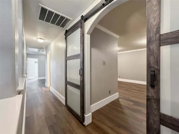 a view of hallway with wooden floor