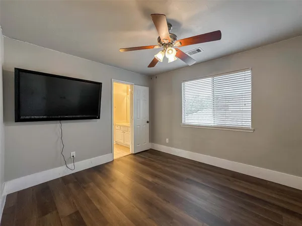 a view of livingroom with furniture flat screen tv and wooden floor