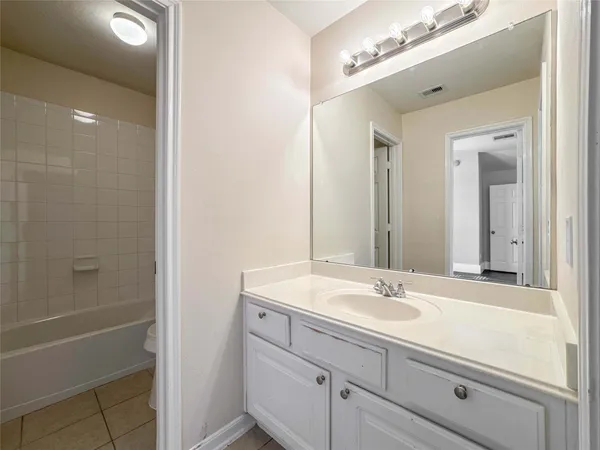a bathroom with a sink double vanity and a mirror